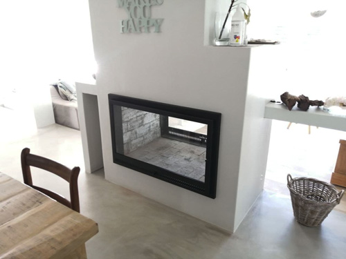 Double sided brick fireplace with frame and single doors